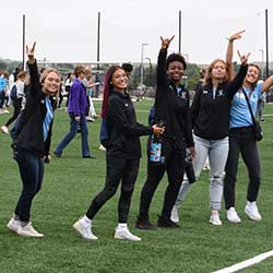 students in a campus football field