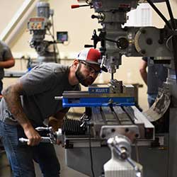 student in class using a machinery